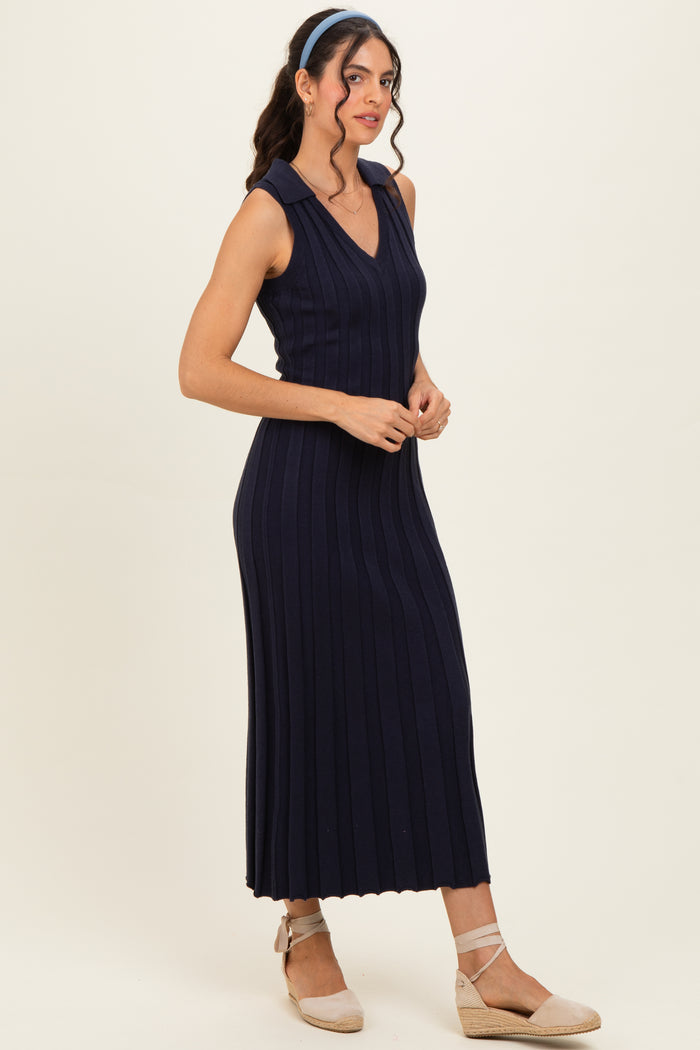woman wearing a navy ribbed sleeveless midi dress with a v-neckline and styled with light brown espadrille flats