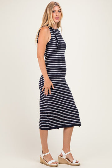woman wearing a navy blue and white striped midi dress with shoulder ties and espadrille wedges