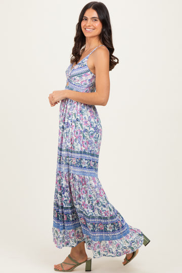 woman wearing a floral print maxi dress with spaghetti straps and a flowing silhouette