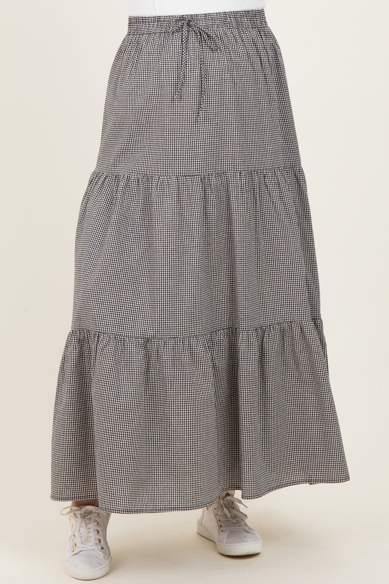 maternity wear black and white gingham tiered maxi skirt with an elastic waistband and sneakers