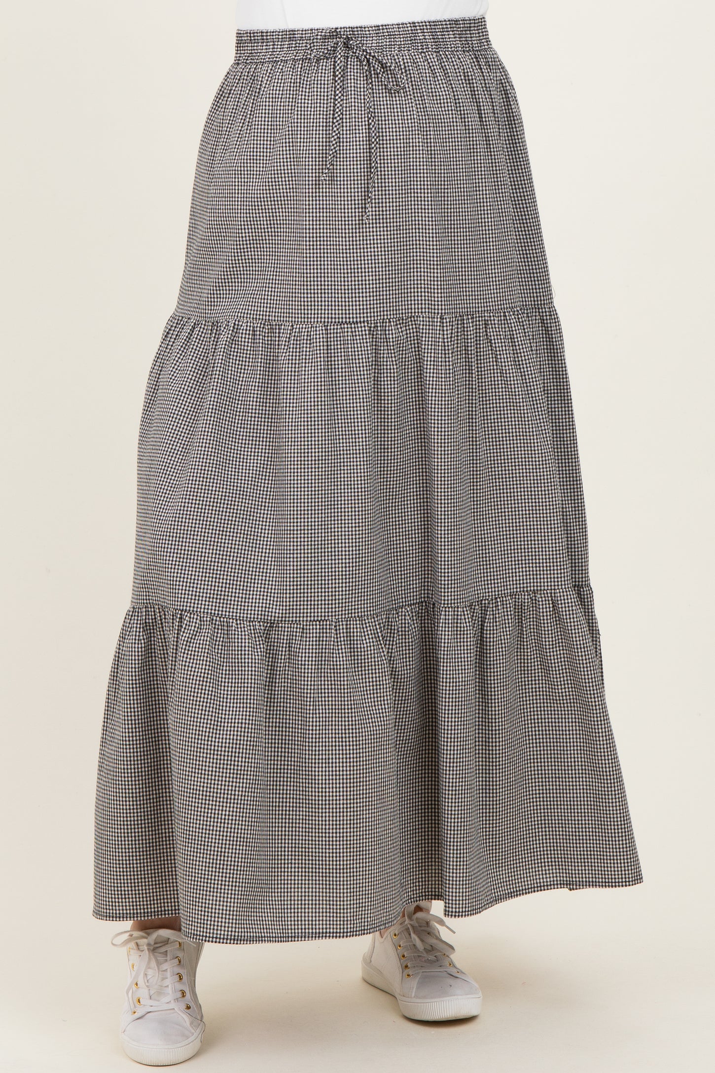 maternity wear black and white gingham tiered maxi skirt with an elastic waistband and sneakers