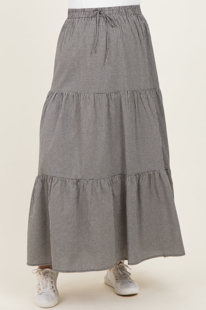 maternity wear black and white gingham tiered maxi skirt with an elastic waistband and sneakers
