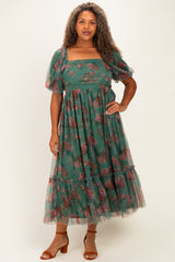 woman wearing a green floral midi dress with puff sleeves and a tiered skirt, styled with brown heeled sandals