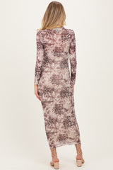 woman wearing a long sleeve maternity dress with a purple and beige abstract pattern, shown from the back