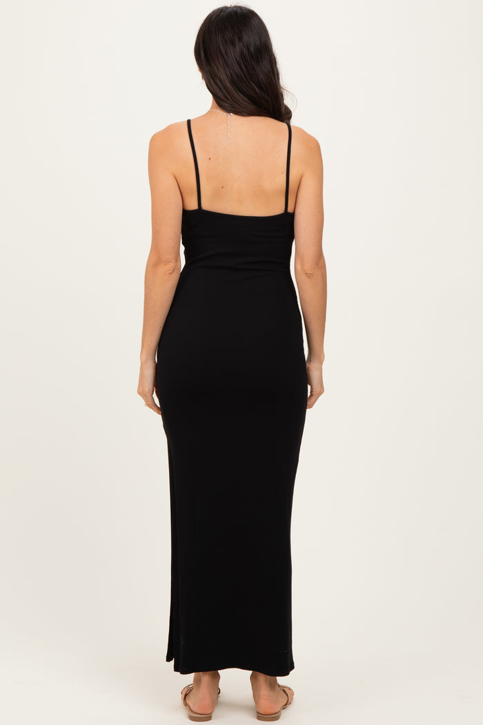 woman wearing a black ribbed maxi dress with spaghetti straps, showing the back view