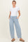 woman wearing a white short sleeve top and light blue maternity jogger pants with pockets