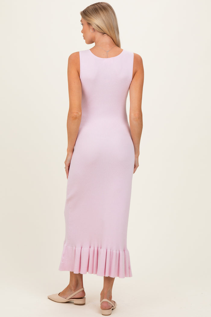 woman wearing a light pink ribbed maternity dress with a flared hem, viewed from the back
