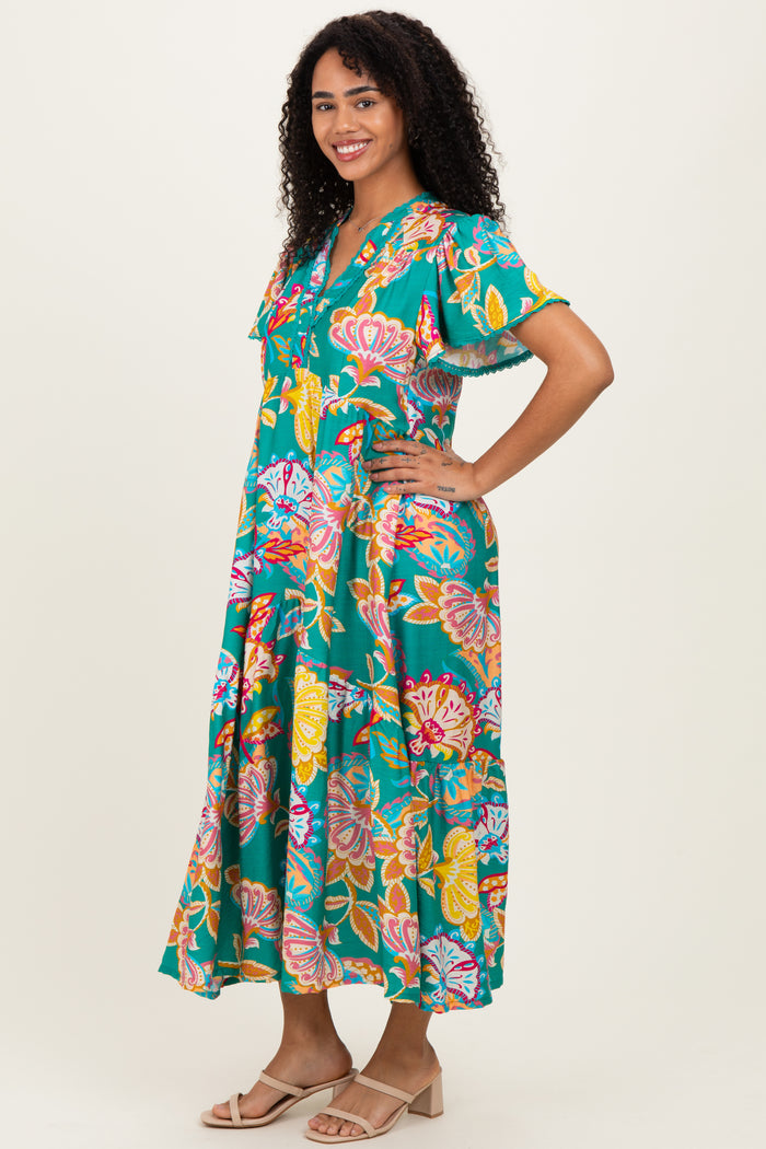 woman wearing a colorful floral print maxi dress with short sleeves and a v-neckline