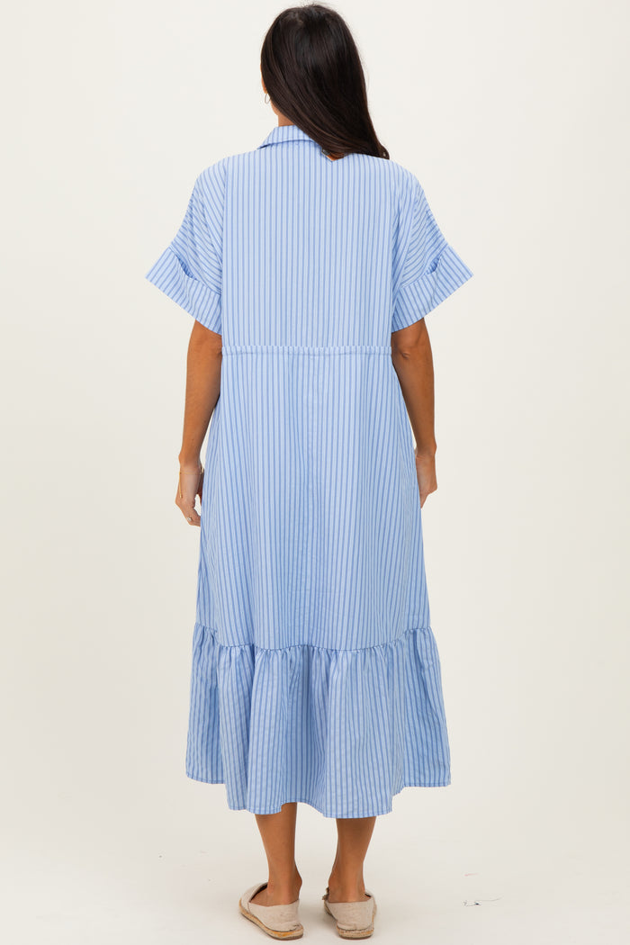 woman wearing a blue and white striped maxi dress with short sleeves and a ruffled hemline, viewed from the back