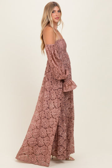 woman wearing a dusty rose off-the-shoulder lace maxi dress with long puff sleeves