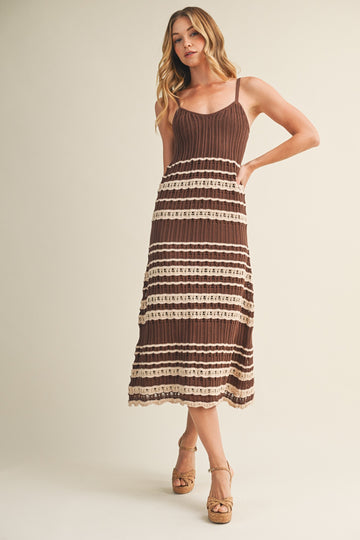 woman wearing a brown and cream striped midi dress with a knitted bodice and adjustable straps