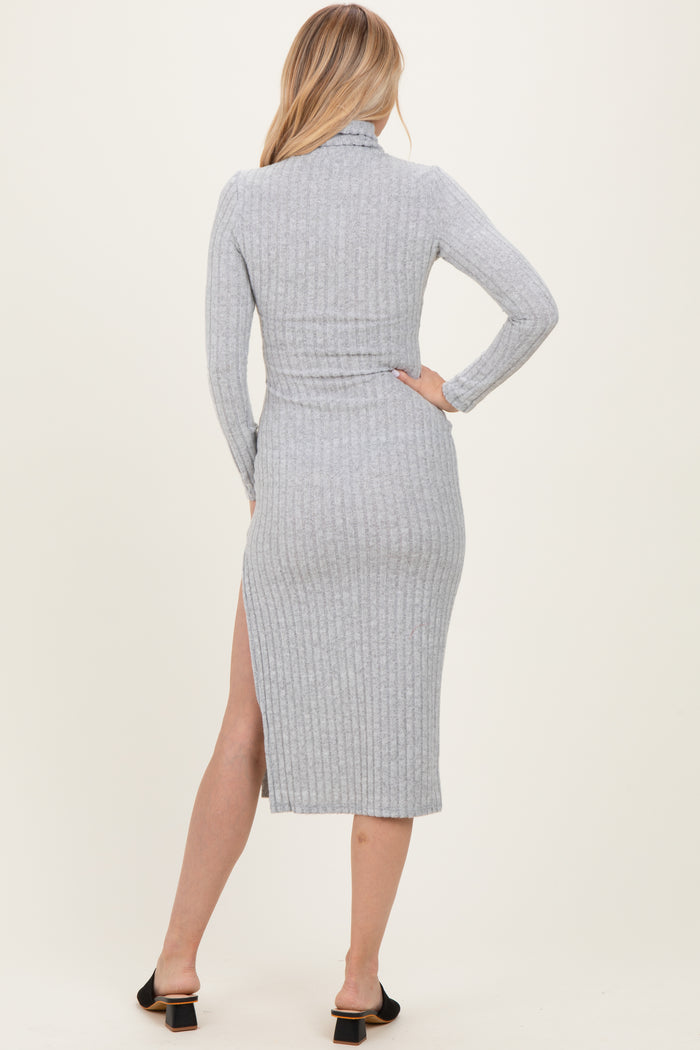 woman wearing a fitted gray ribbed midi dress with a high slit and long sleeves, showing the back view