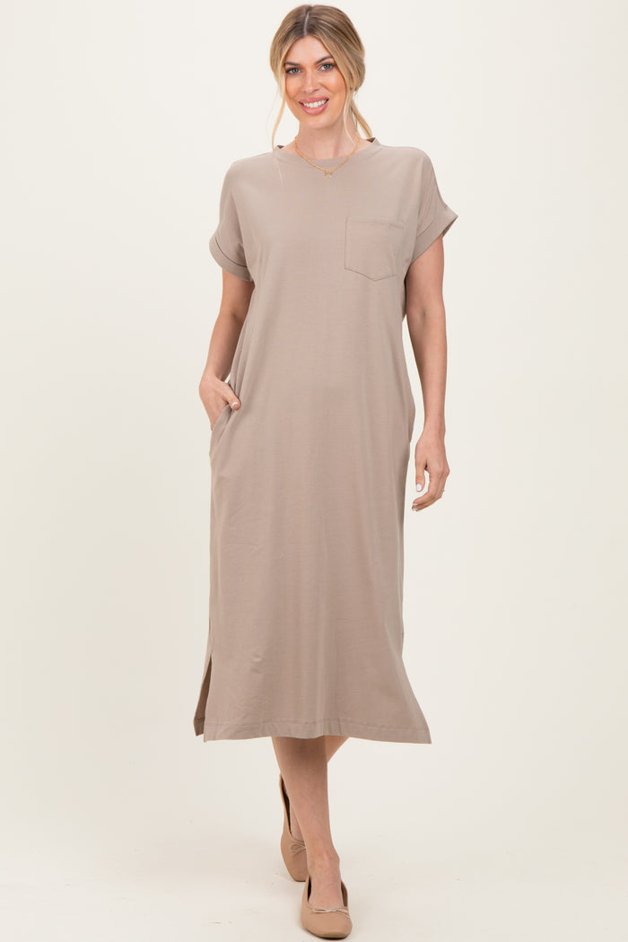 woman wearing a beige short sleeve maxi dress with a pocket and side slits
