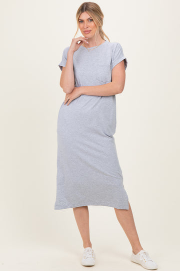 woman wearing a gray maxi t-shirt dress with rolled sleeves and side slits, posing casually