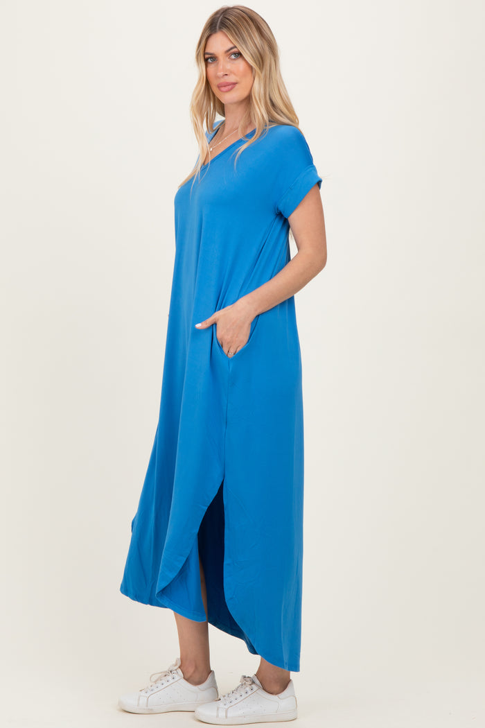 woman wearing a vibrant blue oversized maxi dress with short sleeves and side pockets