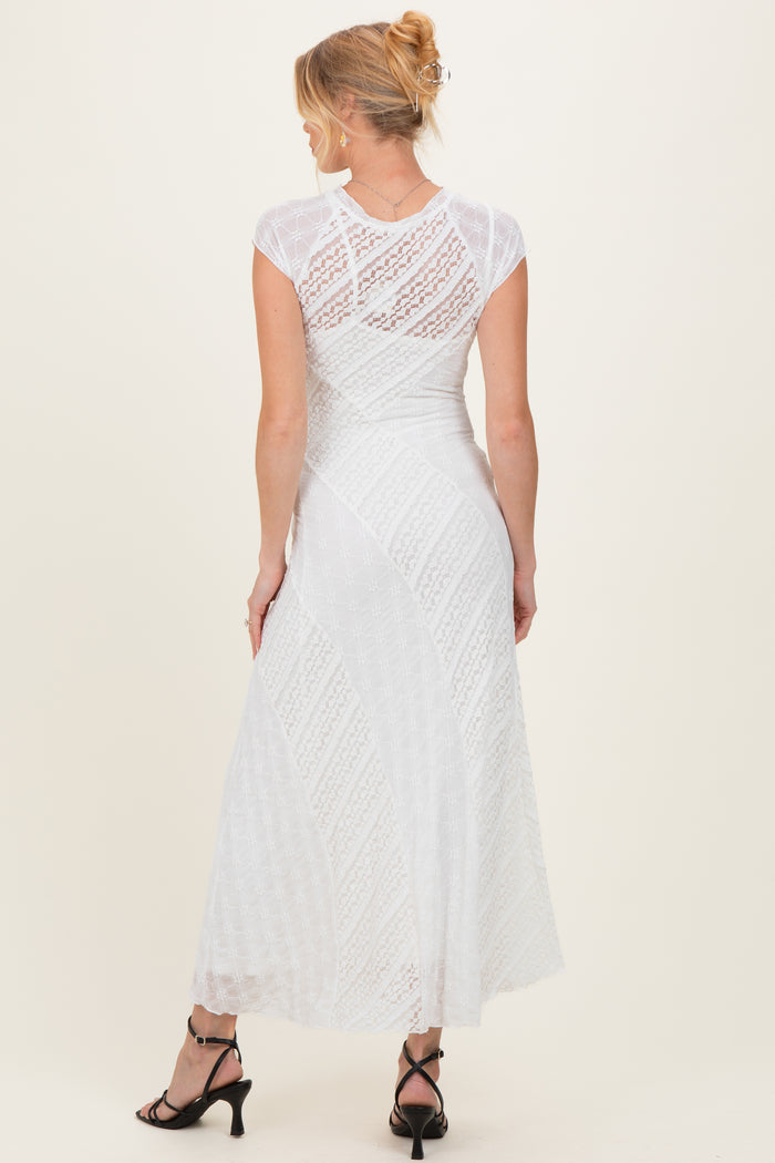 woman wearing a white lace maternity maxi dress with short sleeves, showing the back view