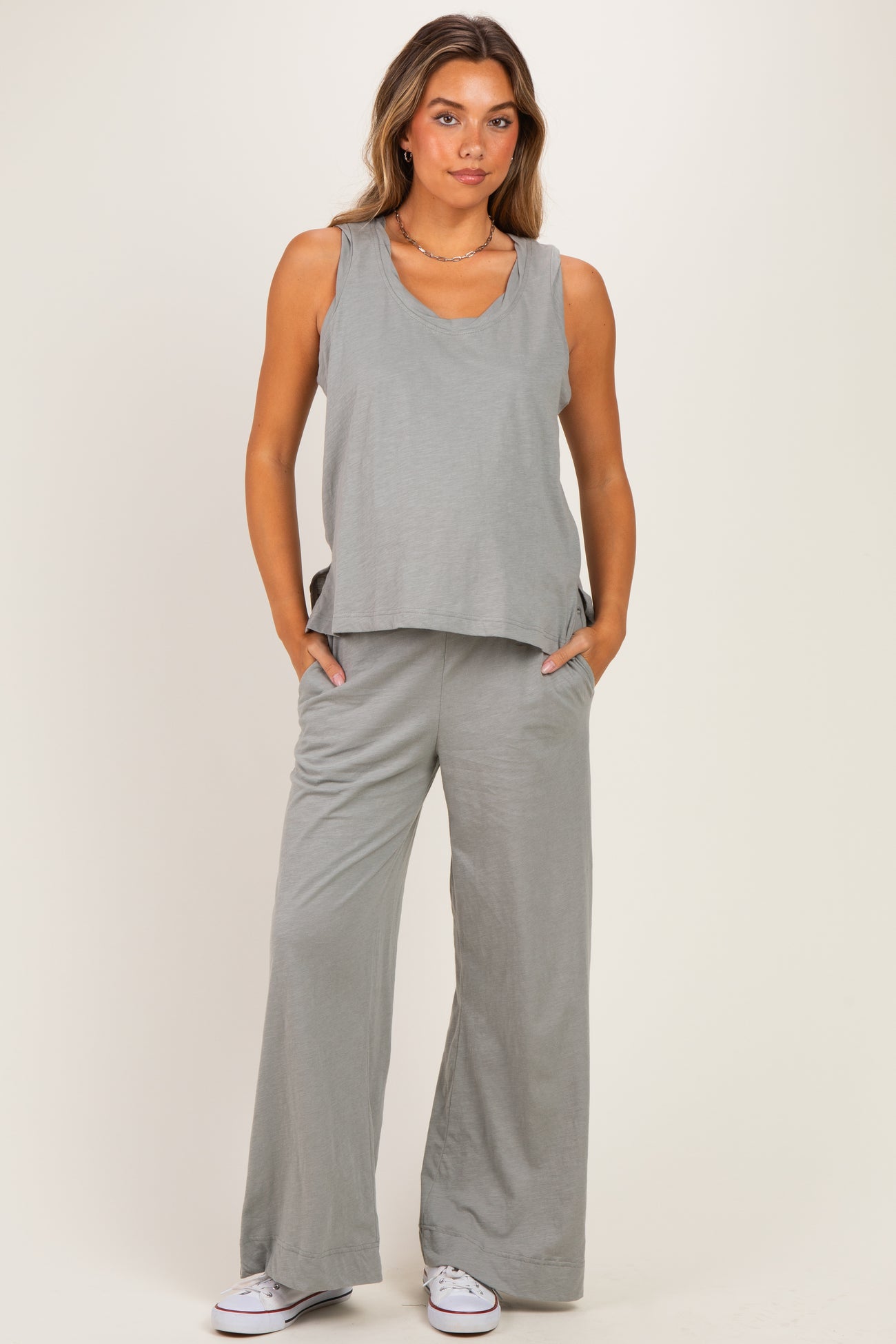 woman wearing a gray maternity tank top and matching wide-leg pants with pockets