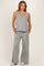 woman wearing a gray maternity tank top and matching wide-leg pants with pockets