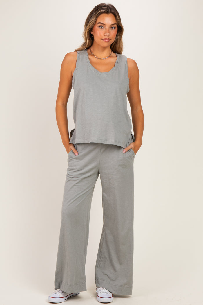 woman wearing a gray maternity tank top and matching wide-leg pants with pockets
