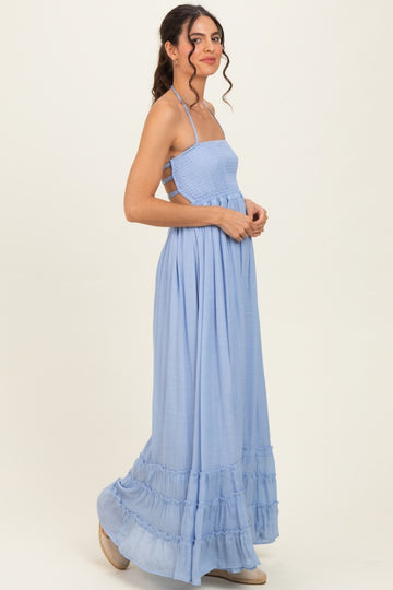 woman wearing a light blue smocked maxi dress with spaghetti straps and tiered ruffle hem