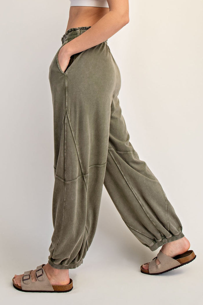 woman wearing olive green relaxed fit jogger pants with elastic waistband and side pockets