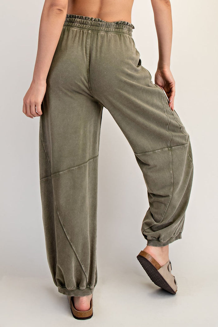 woman wearing olive green elastic waist wide-leg pants with gathered ankles from the back