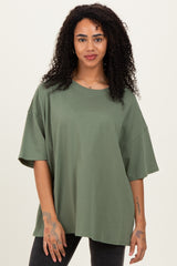 woman wearing an oversized olive green short sleeve t-shirt with a relaxed fit