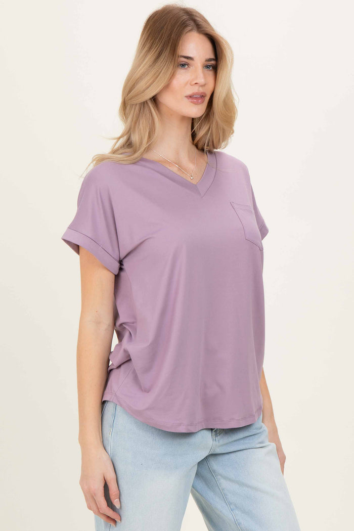 woman wearing a lavender v-neck loose-fit top with rolled sleeves and a front pocket