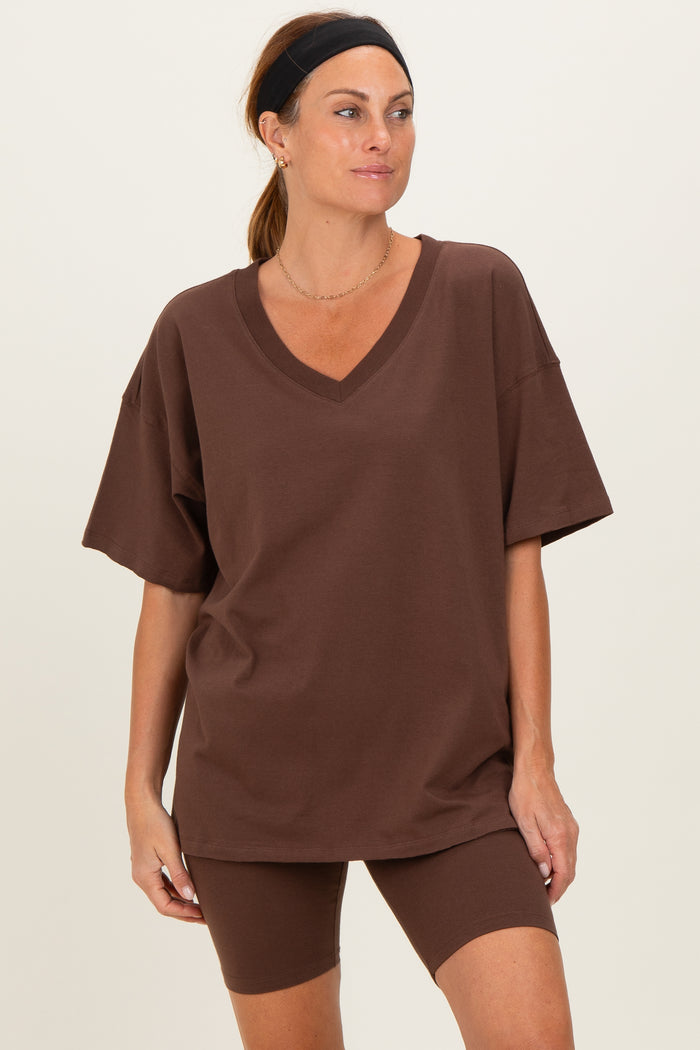woman wearing a brown oversized v-neck t-shirt and matching bike shorts