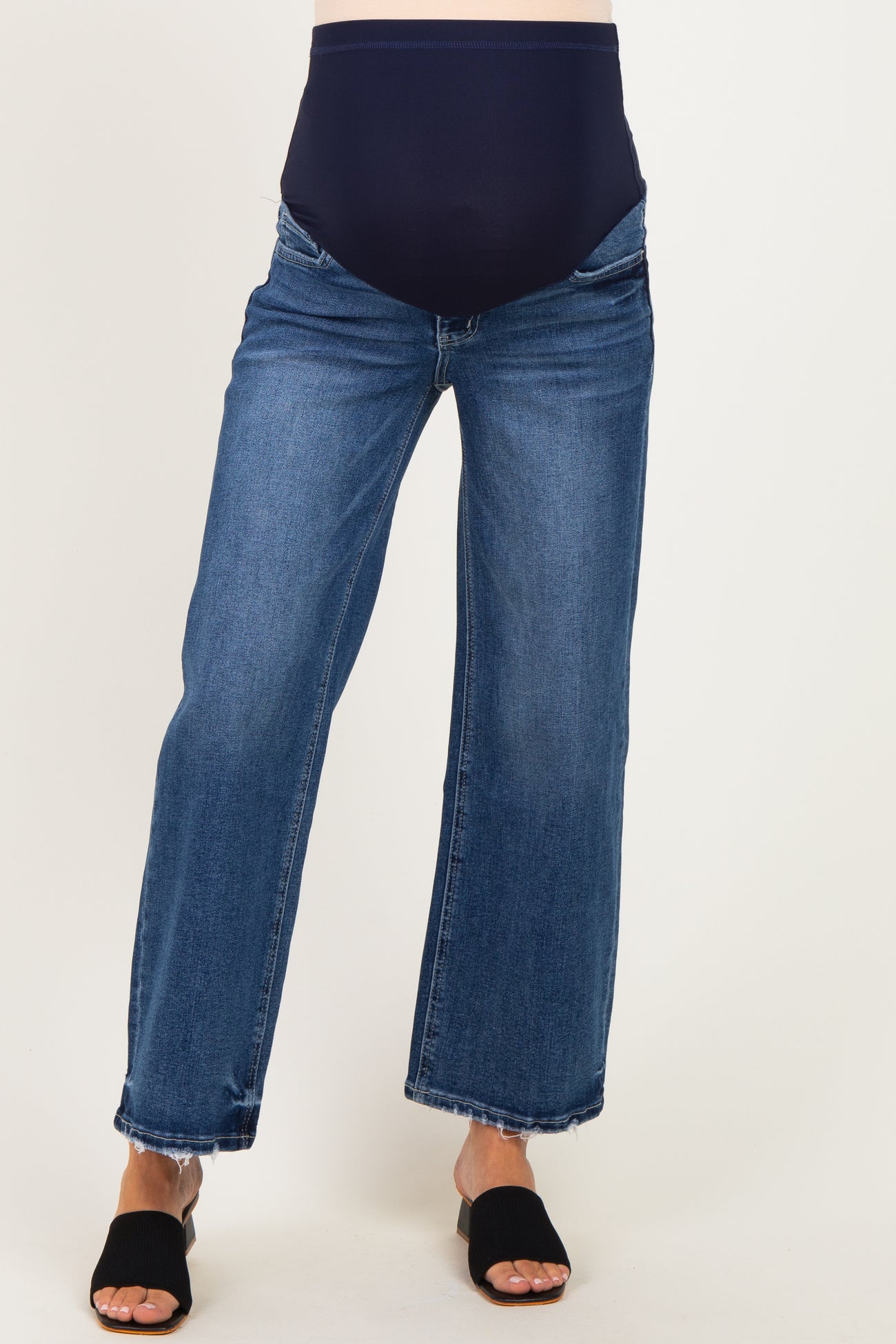 woman wearing dark blue maternity jeans with a wide leg and a navy supportive belly panel