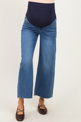 woman wearing a pair of blue maternity wide-leg jeans with a navy belly panel