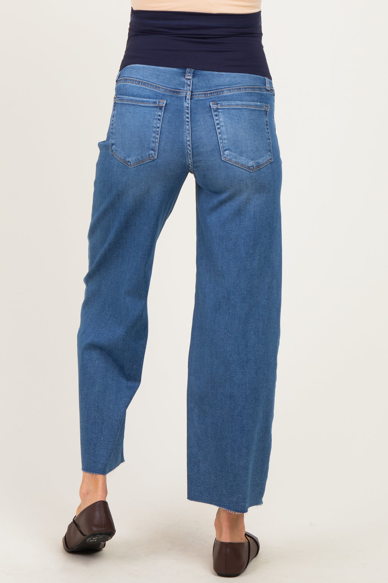 woman wearing maternity wide-leg blue jeans, showing the back view