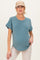 woman wearing a teal maternity t-shirt with rolled sleeves and a subtle curved hem, showing her baby bump