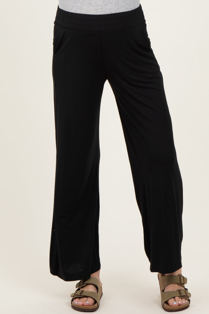 woman wearing black maternity wide-leg pants with an elastic waistband and side pockets