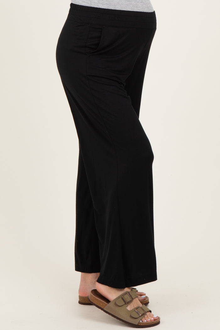 maternity wear black wide-leg pants with side pockets and stretchy waistband, model showing baby bump