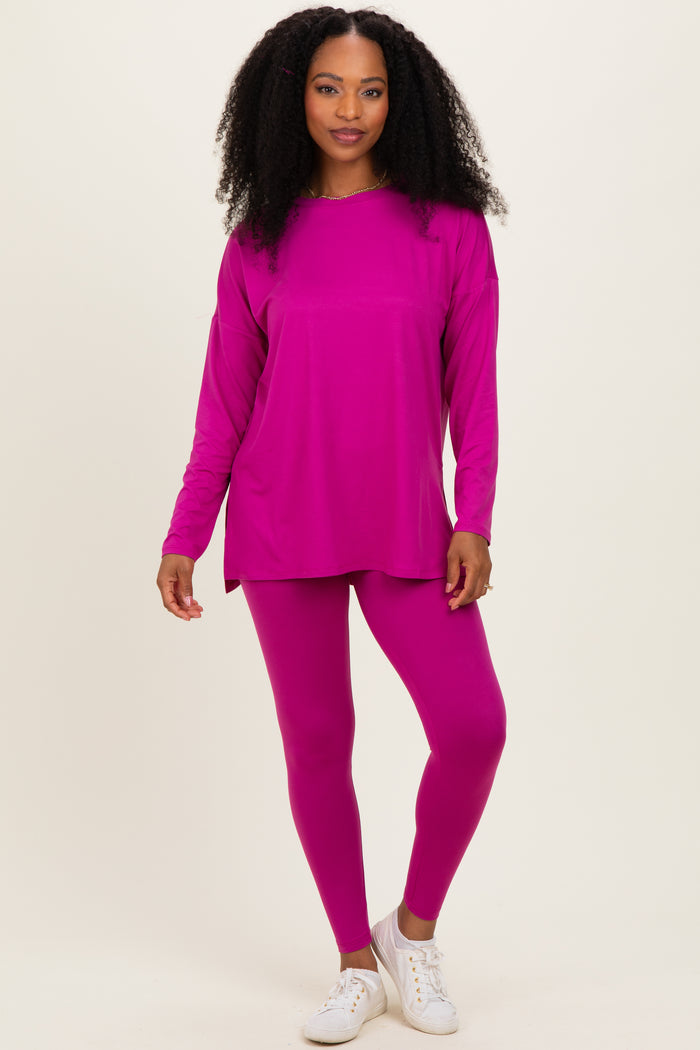woman wearing a bright pink long sleeve top and matching leggings with white sneakers