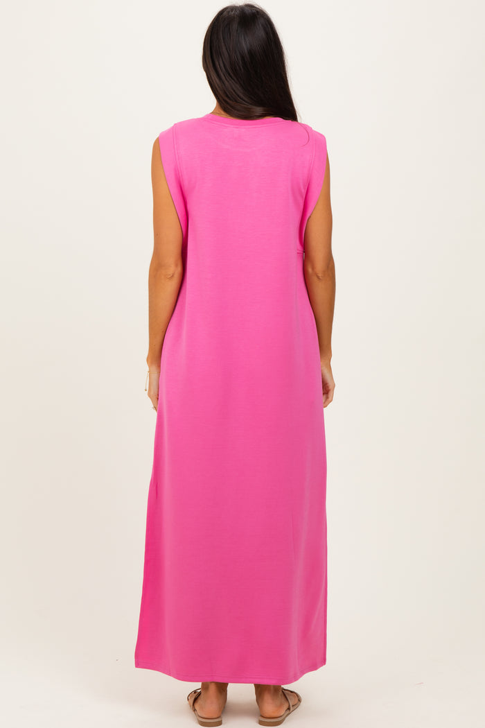 woman wearing a bright pink sleeveless maxi dress, view from the back
