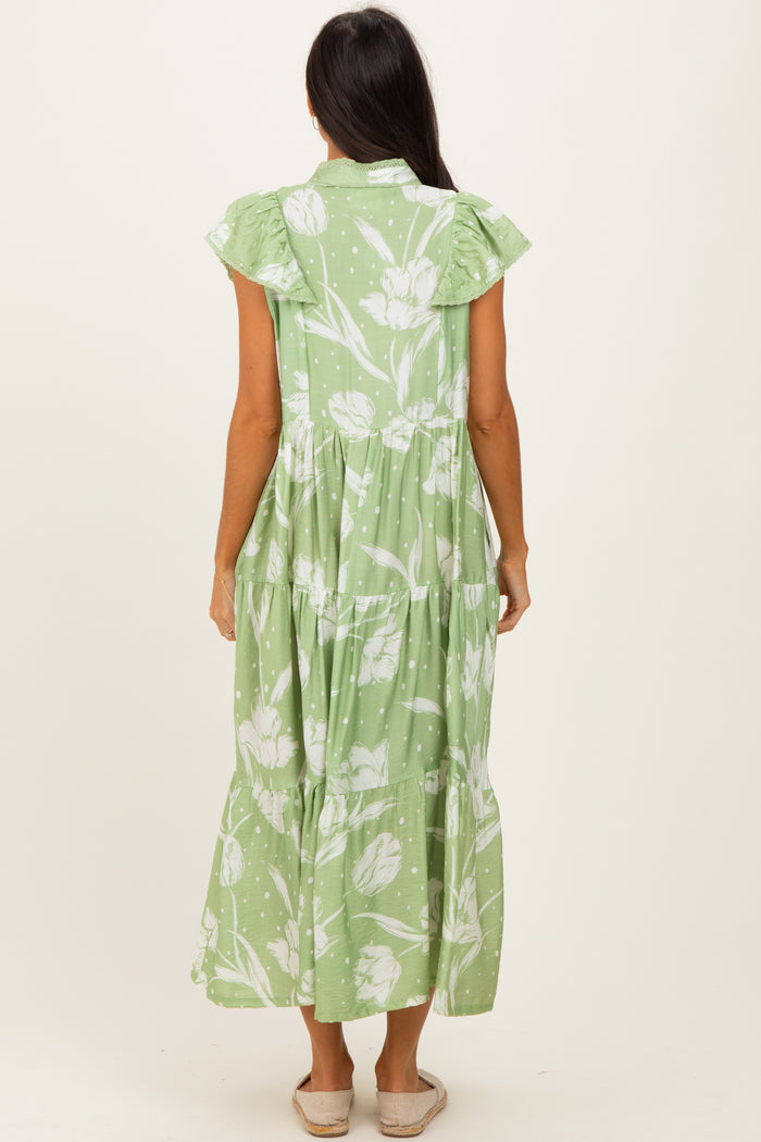 woman wearing a light green floral maxi dress with ruffled sleeves and a tiered skirt, facing away from the camera