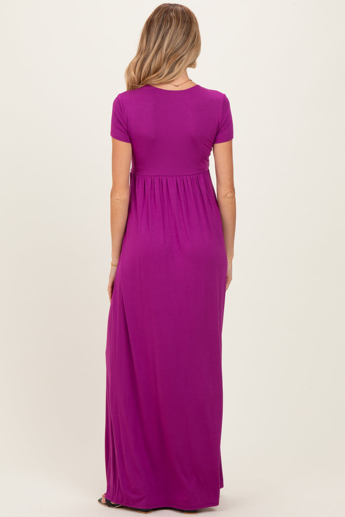 woman wearing a purple short sleeve maternity maxi dress viewed from the back