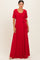 woman wearing a red lace maxi dress with a scoop neckline and a tie waist detail