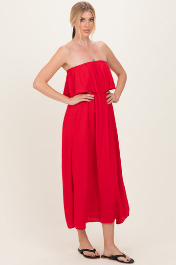 woman wearing a vibrant red strapless maxi dress with a ruffled bodice and a flowing skirt