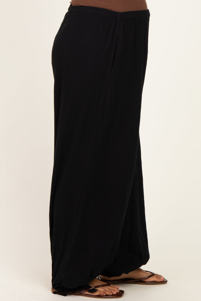 maternity wear black wide-leg pants with a relaxed fit, model wearing with flat sandals and a fitted top