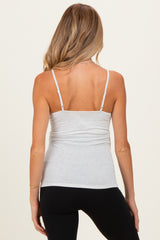 woman wearing a light gray maternity tank top with adjustable spaghetti straps and fitted style