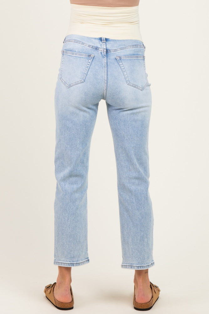 woman wearing light wash maternity jeans with a stretchy waistband, showing the back view