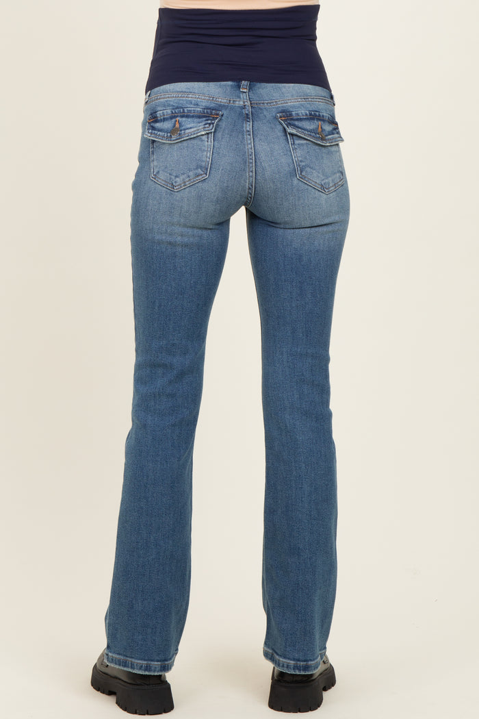 woman wearing light blue maternity jeans from the back with a black waistband and casual footwear