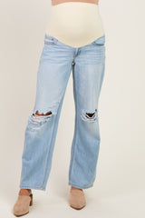 woman wearing light blue distressed maternity jeans with a beige belly panel