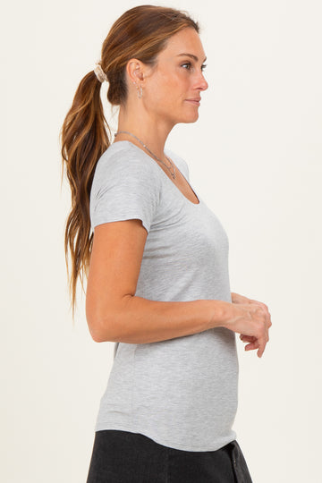 woman wearing a light gray short sleeve t-shirt with a scoop neckline styling and side view pose