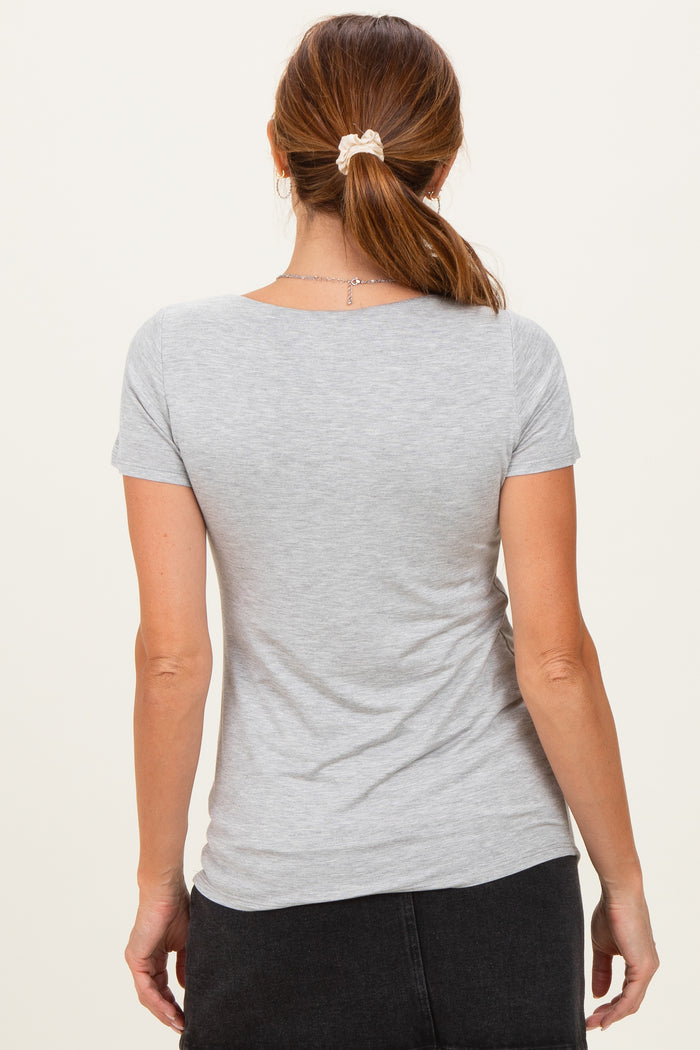 woman wearing a gray short sleeve t-shirt, viewed from the back, with a loose fit and soft texture