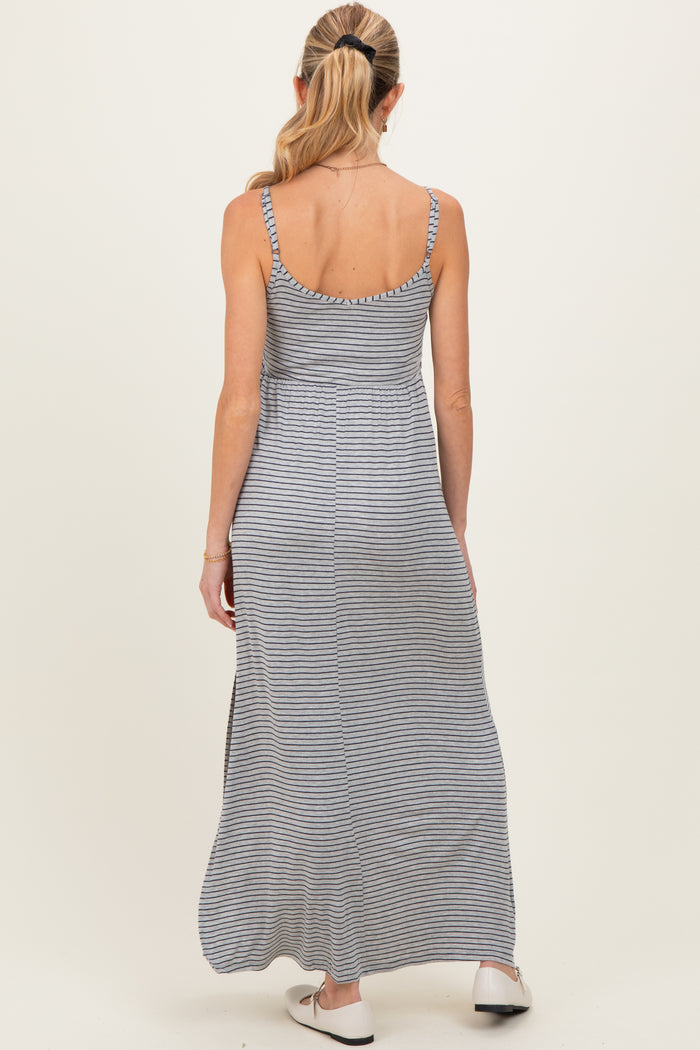 woman wearing a gray and white striped maternity maxi dress with adjustable spaghetti straps and a relaxed fit