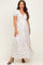 woman wearing a floral print maternity maxi dress with short puff sleeves and a v-neckline
